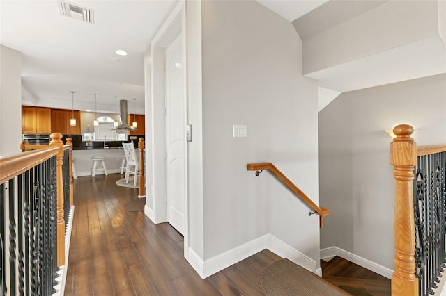 corridor with sink and dark hardwood / wood-style floors