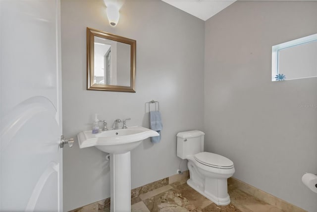 bathroom with tile flooring and toilet