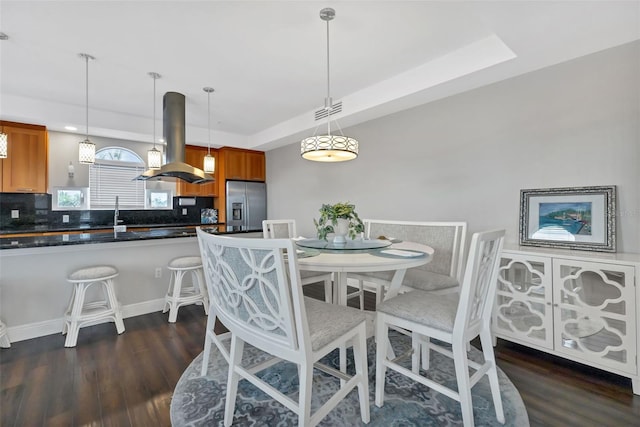 dining area featuring dark wood-type flooring