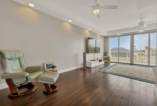 sitting room with ceiling fan and dark hardwood / wood-style floors