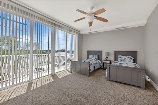 carpeted bedroom featuring ceiling fan and access to exterior