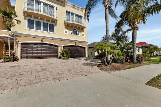 view of front of house featuring a garage and a balcony