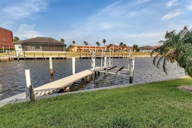 view of dock with a yard and a water view