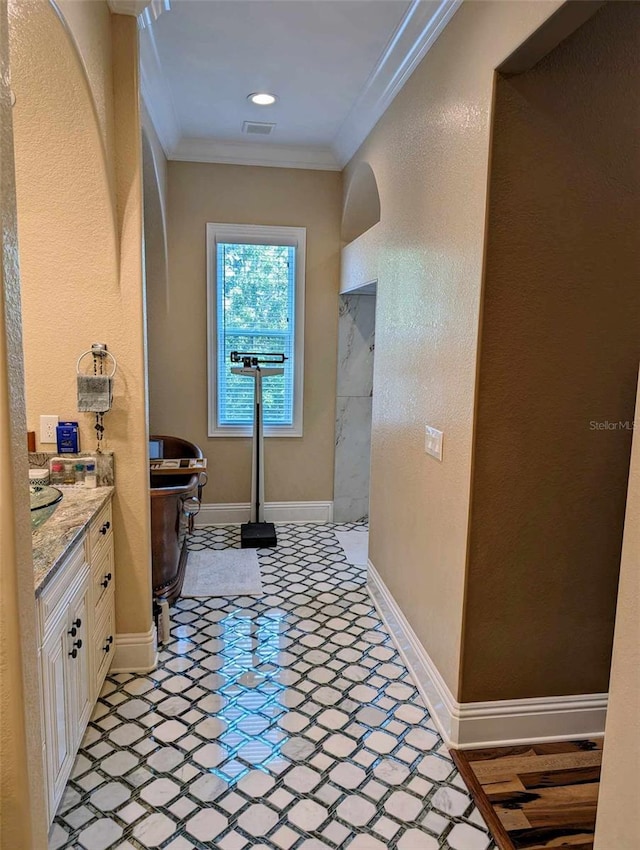 bathroom with tile patterned flooring, crown molding, and vanity