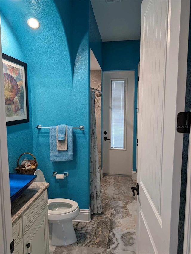 bathroom with vanity, tile patterned flooring, and toilet