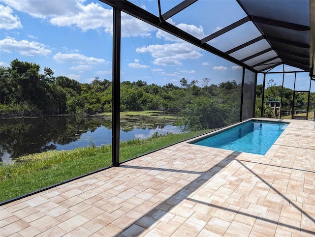 view of swimming pool with a patio, a water view, and a lanai