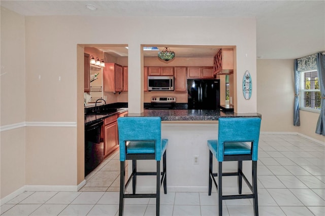 kitchen with kitchen peninsula, light tile floors, and black appliances