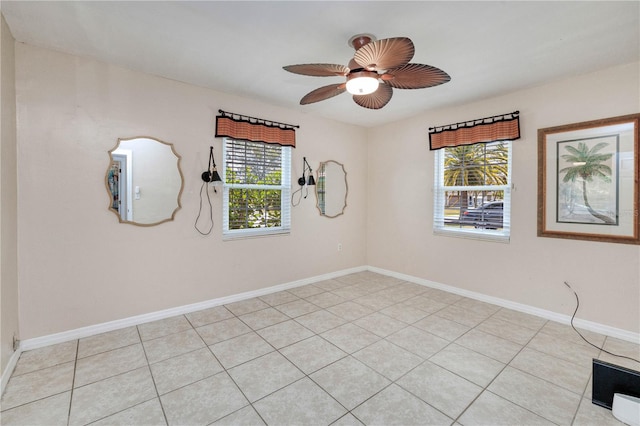 tiled spare room featuring plenty of natural light and ceiling fan