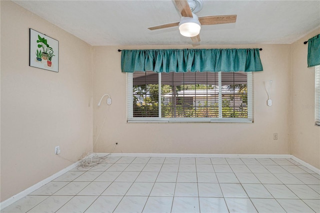 empty room with ceiling fan and tile flooring