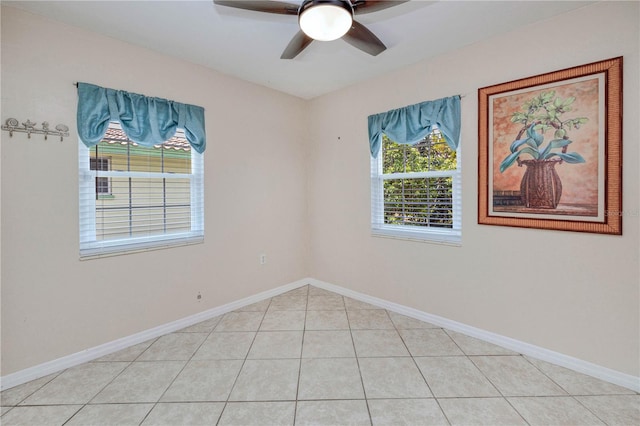 empty room featuring ceiling fan and light tile flooring