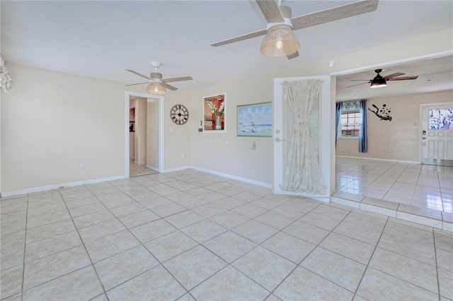 spare room with ceiling fan and light tile flooring