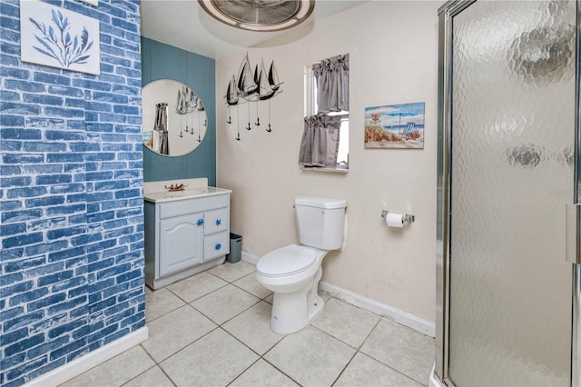 bathroom with tile floors, vanity with extensive cabinet space, toilet, and a shower with shower door