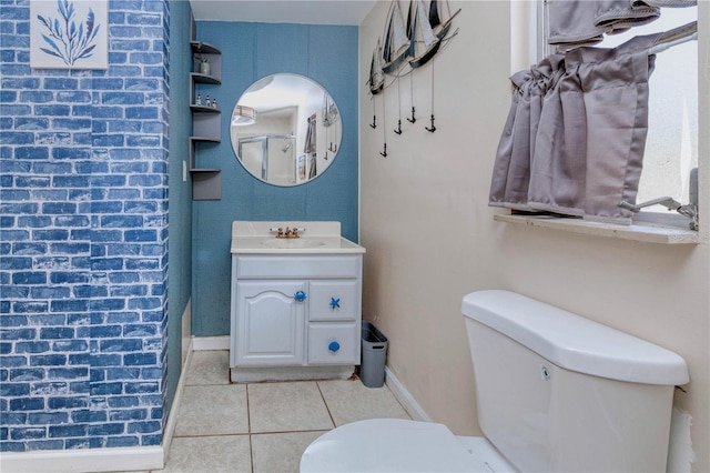 bathroom featuring toilet, tile floors, and vanity