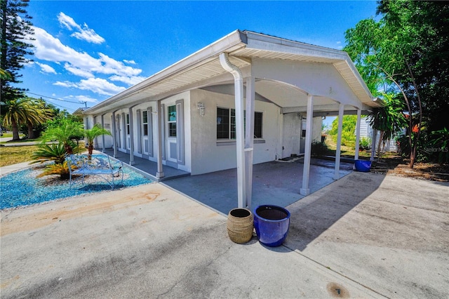 view of side of property featuring a patio area