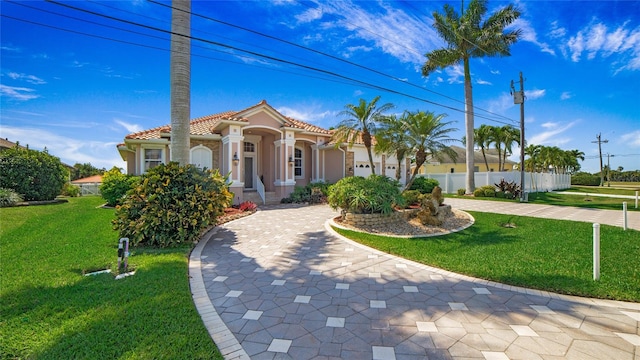 mediterranean / spanish-style house featuring a front lawn