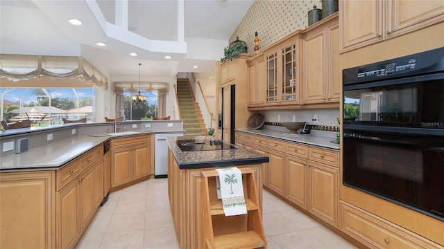 kitchen with a kitchen island, a towering ceiling, black appliances, and light tile floors