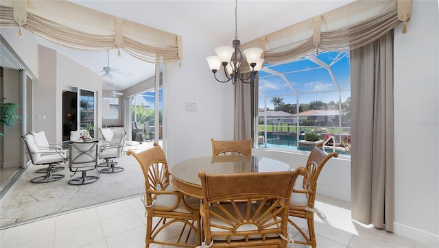 tiled dining area with a healthy amount of sunlight and ceiling fan with notable chandelier