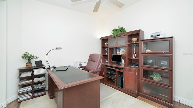 home office featuring light hardwood / wood-style floors and ceiling fan