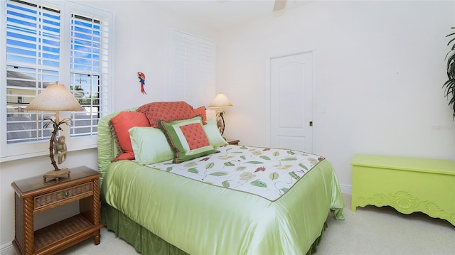 bedroom with a closet, ceiling fan, and carpet flooring