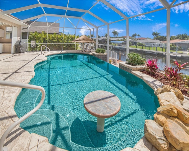 view of swimming pool with area for grilling, a lanai, and a patio area