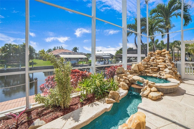 view of pool with a patio and glass enclosure