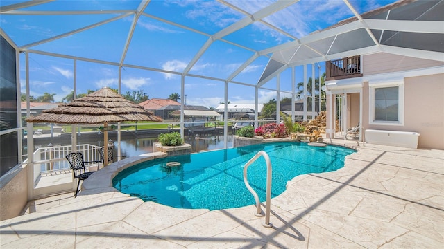 view of pool with a patio area, a water view, and glass enclosure