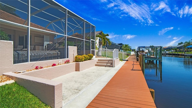 dock area featuring a water view and glass enclosure