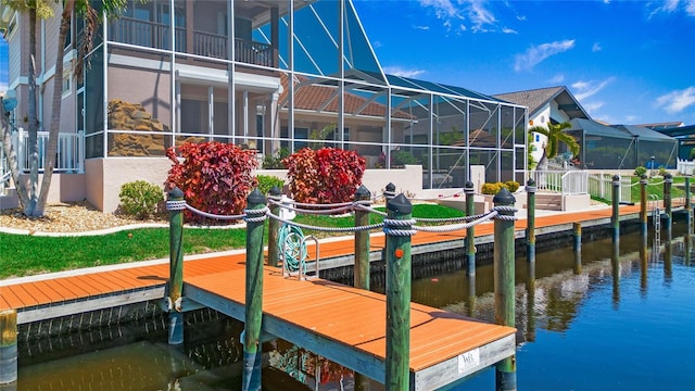 view of dock featuring glass enclosure and a water view