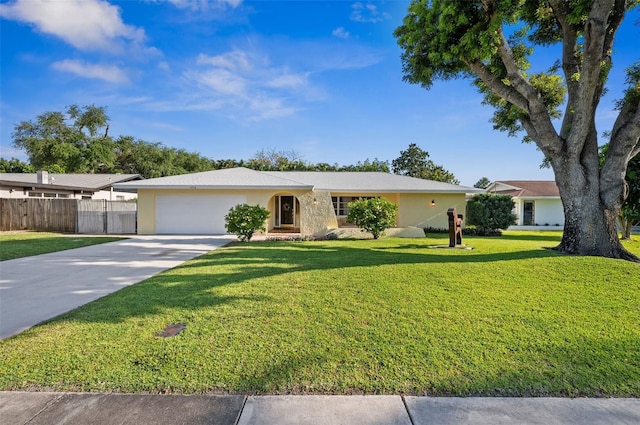 ranch-style home featuring a garage and a front lawn