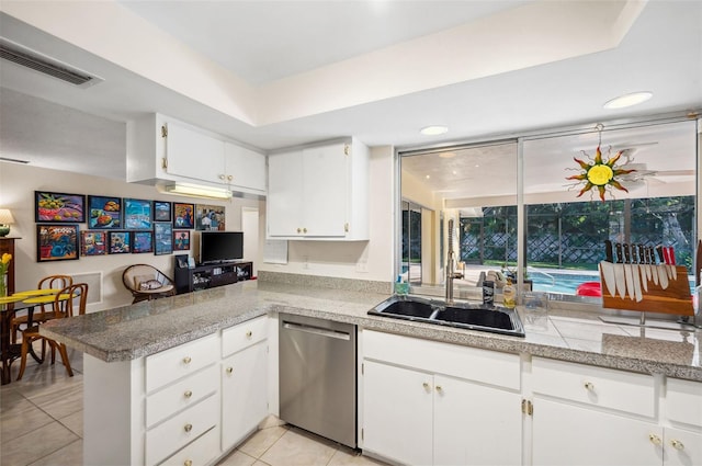 kitchen with kitchen peninsula, dishwasher, white cabinetry, sink, and light tile floors