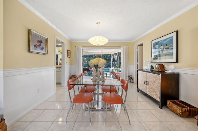 dining space featuring ornamental molding, light tile flooring, and a textured ceiling