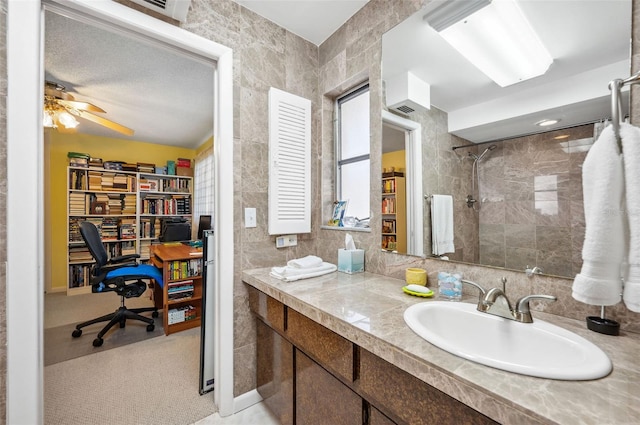 bathroom featuring ceiling fan, tile walls, and large vanity