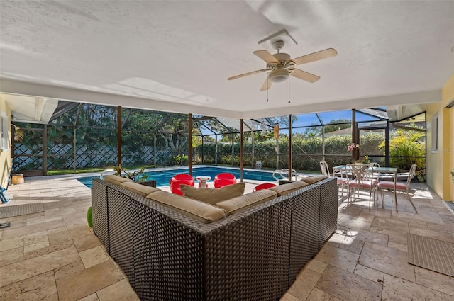 sunroom / solarium featuring ceiling fan