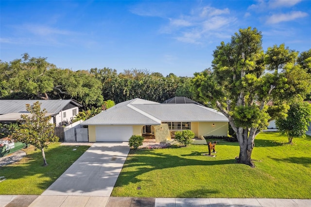 view of front of home with a front lawn and a garage