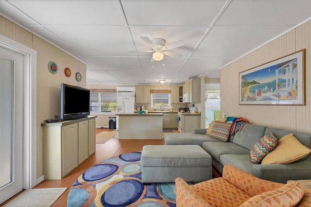 living room with light hardwood / wood-style flooring, sink, and ceiling fan