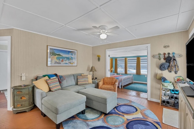 living room featuring coffered ceiling, light hardwood / wood-style floors, and ceiling fan