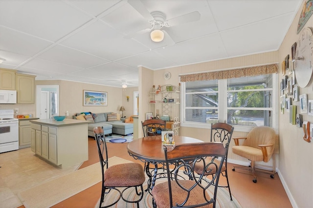 tiled dining space with ceiling fan