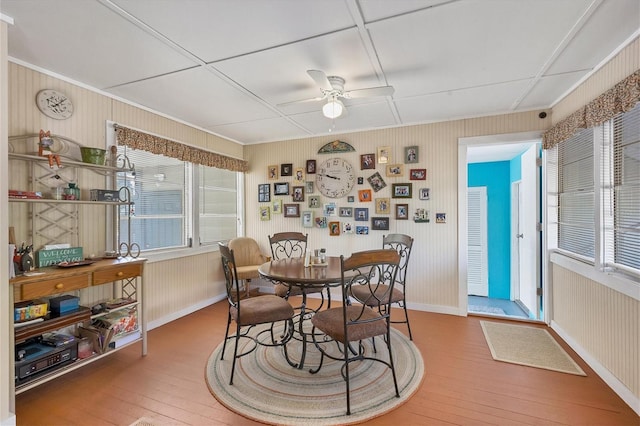 dining area with hardwood / wood-style floors and ceiling fan