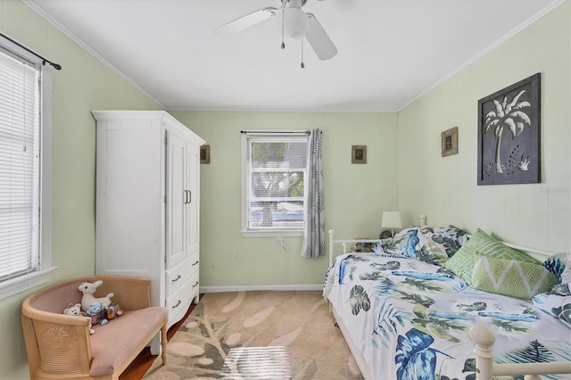 bedroom with ceiling fan, light carpet, and crown molding