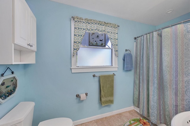 bathroom with toilet and tile flooring