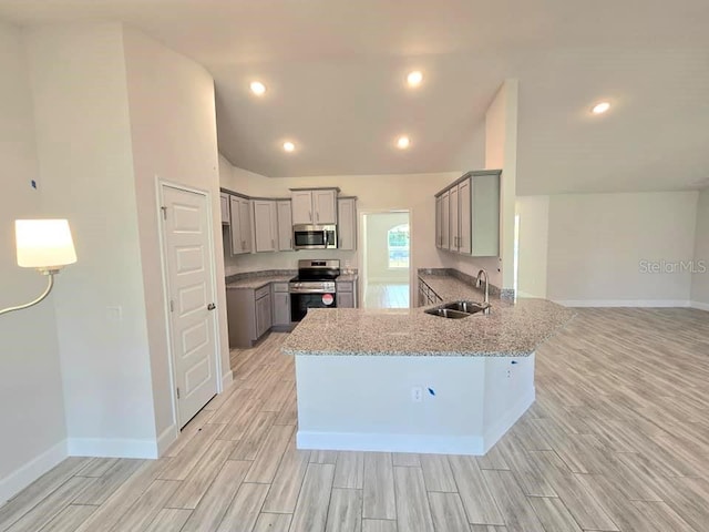 kitchen with gray cabinets, kitchen peninsula, sink, and stainless steel appliances