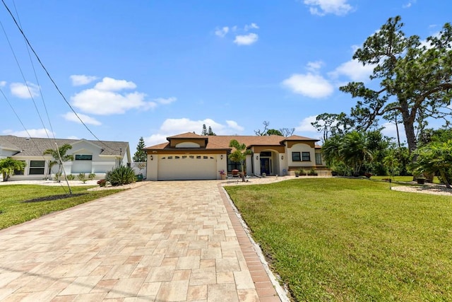 view of front of house featuring a garage and a front yard