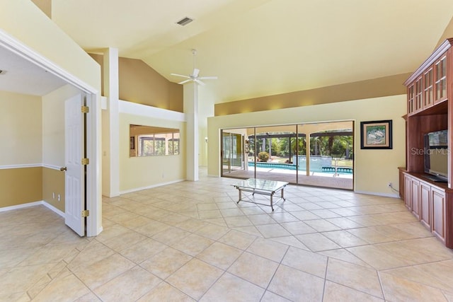 unfurnished living room with high vaulted ceiling, ceiling fan, and light tile floors