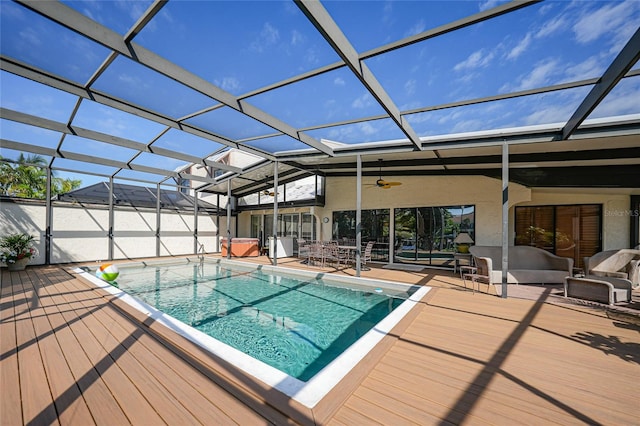 view of swimming pool with a patio area, ceiling fan, a jacuzzi, and glass enclosure