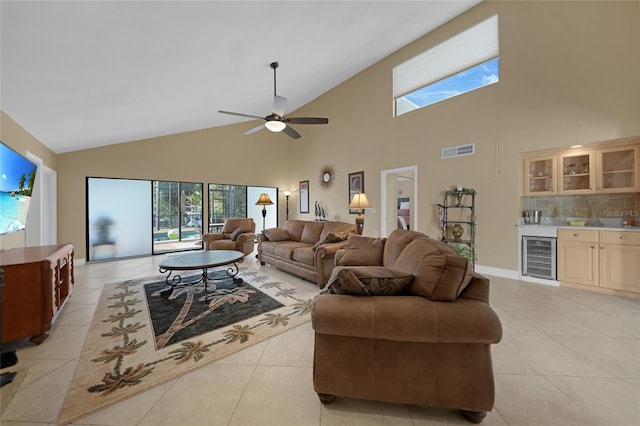 tiled living room with high vaulted ceiling, wine cooler, and ceiling fan