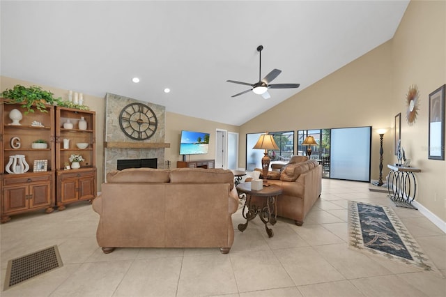 living room featuring high vaulted ceiling, ceiling fan, a stone fireplace, and light tile floors