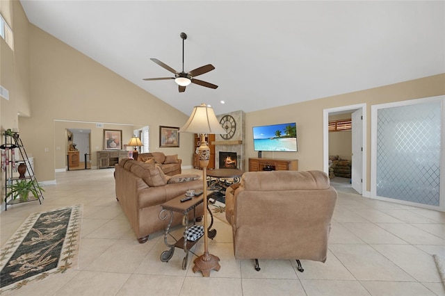 living room with high vaulted ceiling, ceiling fan, light tile flooring, and a large fireplace