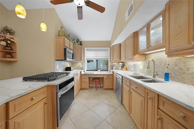 kitchen with sink, vaulted ceiling, backsplash, and stainless steel appliances