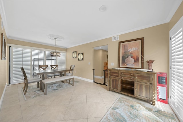 dining area featuring a healthy amount of sunlight, crown molding, light tile floors, and a chandelier