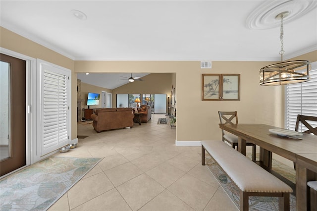 dining area featuring ceiling fan with notable chandelier, crown molding, and light tile flooring